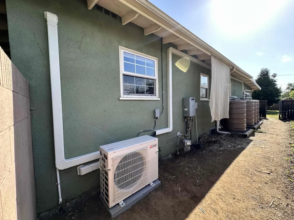 AC outdoor unit next to a house