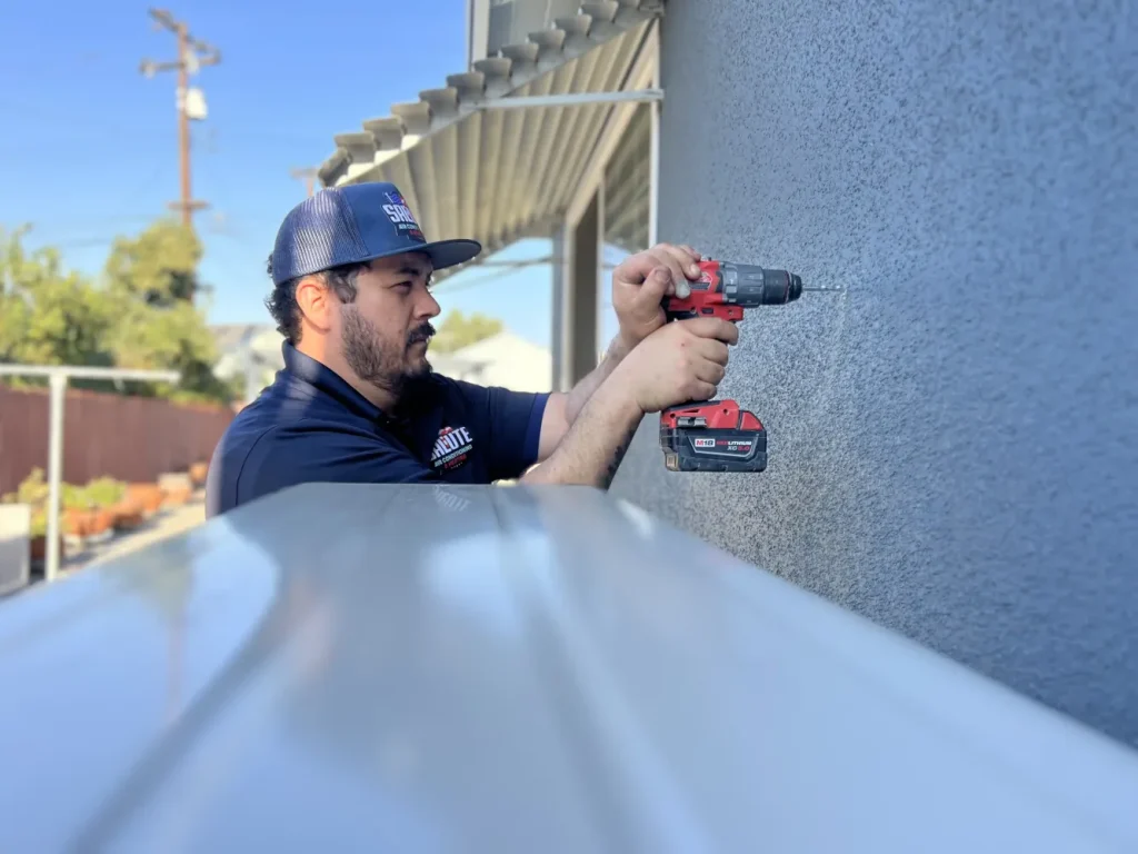 Salute technician drilling wall