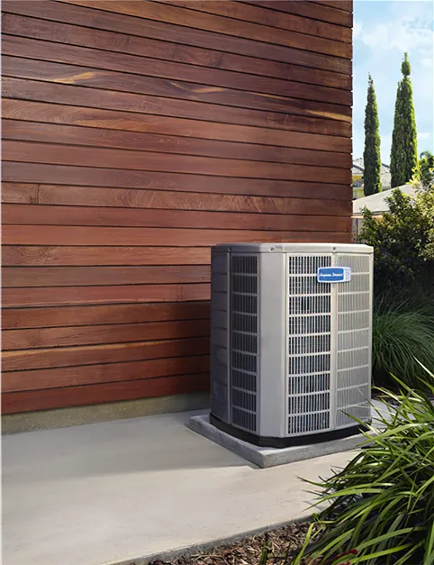 Heat pump next to a wood plank wall