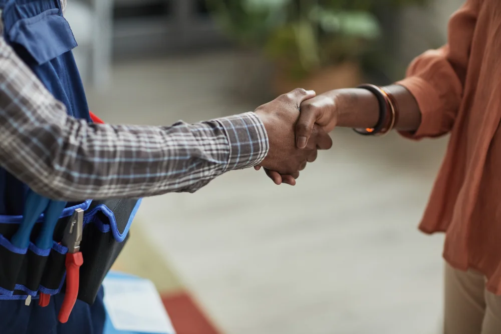 Woman shaking hands with hvac technician